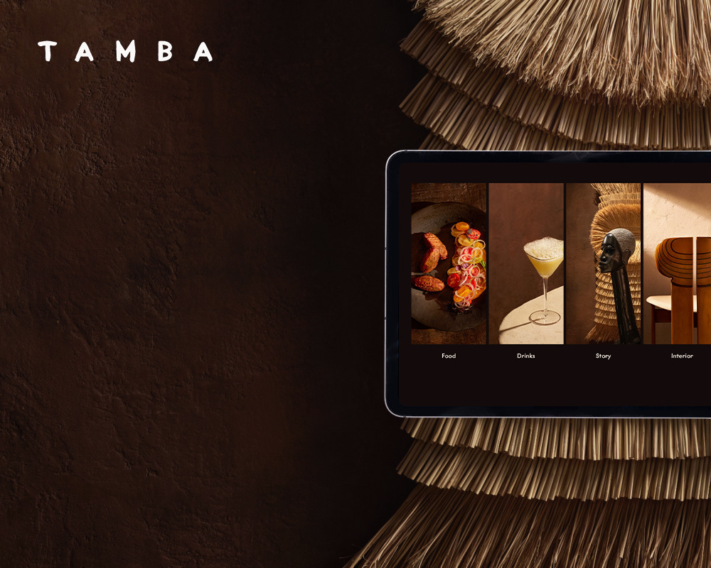 Tablet displaying a web design with categories for food drinks story and interior.